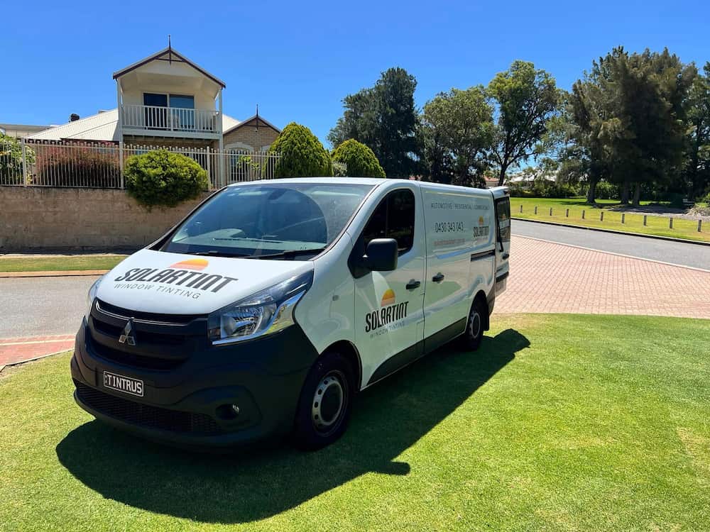 A Solartint company van parked outside a Perth house on a sunny day, ready for expert Perth tinting.